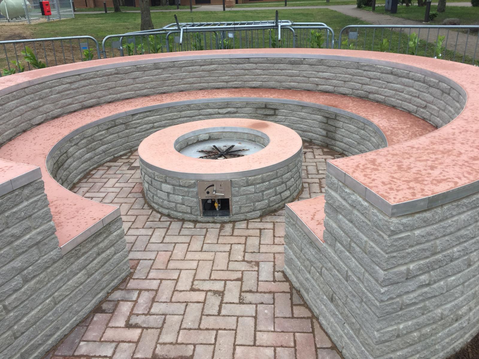 Completed circular gas fire-pit seating with stainless-steel gas controls installed at RAF Lakenheath