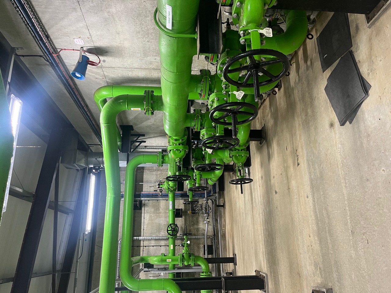 Green fuel pipework and valve assemblies inside an installation at RAF Fairford