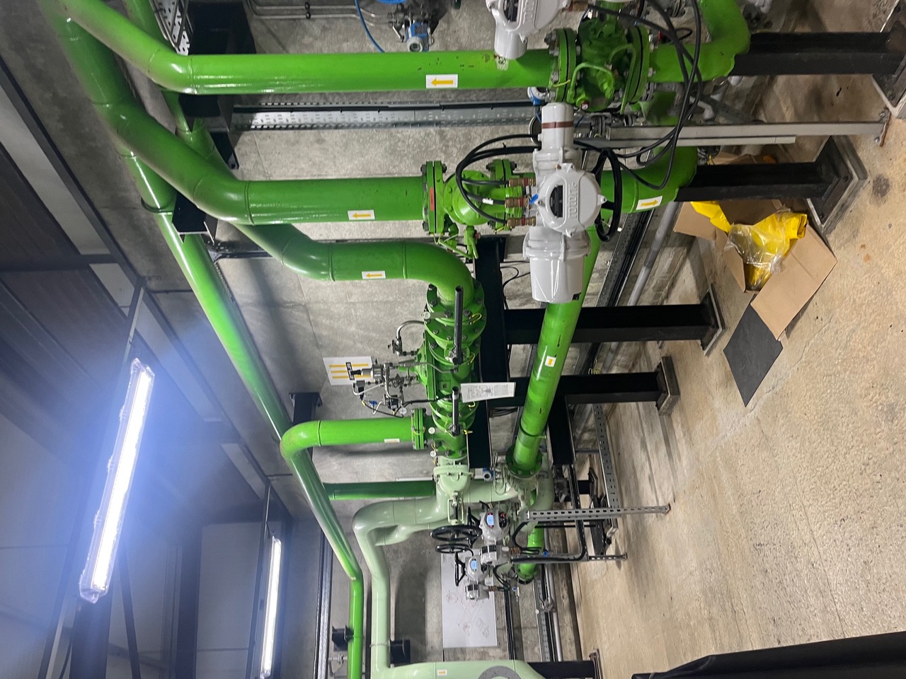 Green fuel pipework, valves and control equipment inside an installation at RAF Fairford