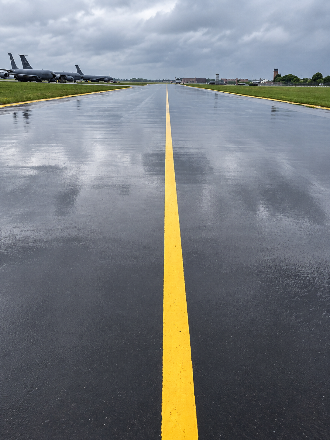 New yellow centreline marking on a wet airfield pavement at RAF Mildenhall
