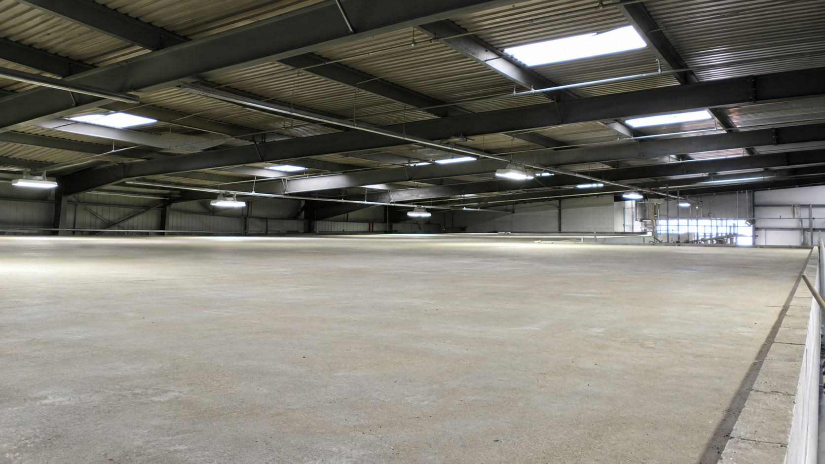 Completed concrete floor slab inside a steel-framed building at RAF Mildenhall